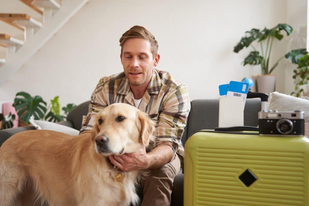 Pooches brand guide showing essential items packed in suitcase for dog boarding preparation.